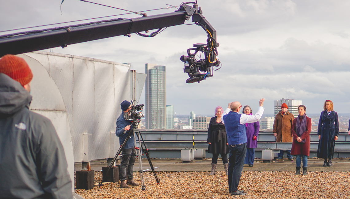 Chorus Director William Spaulding and the chorus in rehearsal for ROH Unmasked on the rooftop of the Royal Opera House ©2021 ROH. Photograph by Danielle Patrick